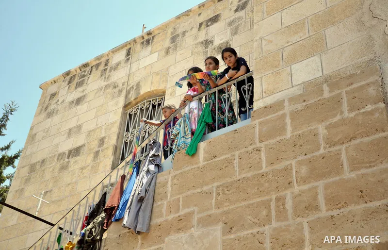 Displaced Palestinian children play as they are celebrating the Eid al-Fitr festival at the Saint Porphyrios church, in Gaza city on July 28, 2014. Security Council agreed on a statement urging Israel, Palestinians and I...