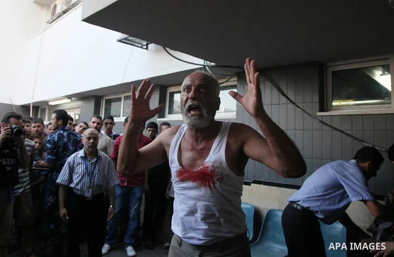 A Palestinian man reacts after an explosion that medics said killed eight children and two adults, and wounded 40 others at a public garden, at the Shifa hospital in Gaza City July 28, 2014. At least 10 Palestinians are...
