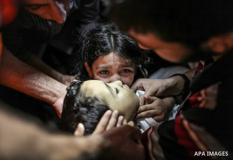 Ansam 9 years,looks to the body of her brother Sameh Jned 4 years during the last look to his body in their family house attend the funeral in jabaliya refugee camp North Gaza Strip on 28 July 2014 Sameh were shot from a...