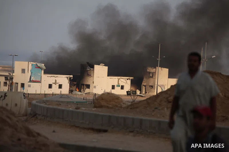 Smoke rises from the Seaport of Gaza City following shelling by the Israeli Navy, on July 29, 2014. Bloodshed in and around Gaza surged with strikes killing at least 13 Palestinians, a day after five Israeli soldiers die...
