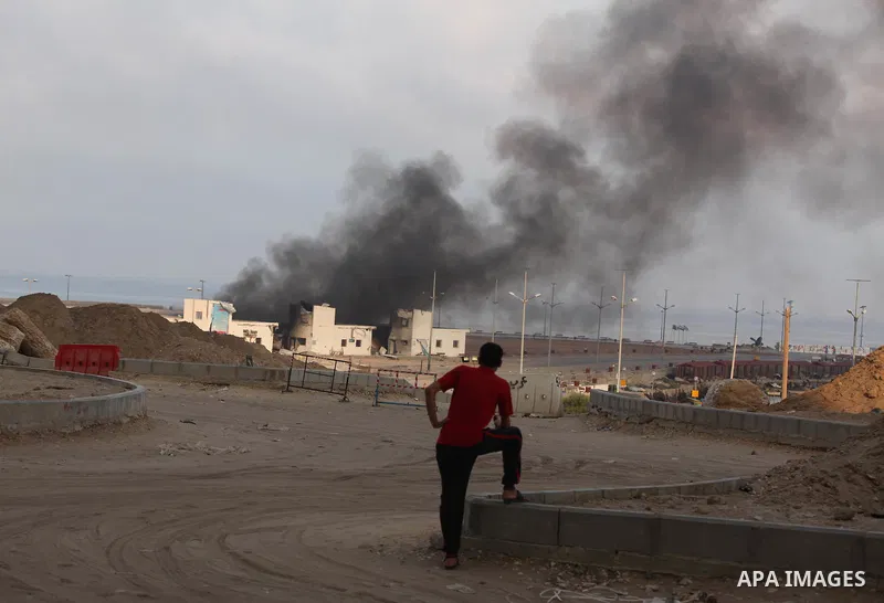 Smoke rises from the Seaport of Gaza City following shelling by the Israeli Navy, on July 29, 2014. Bloodshed in and around Gaza surged with strikes killing at least 13 Palestinians, a day after five Israeli soldiers die...