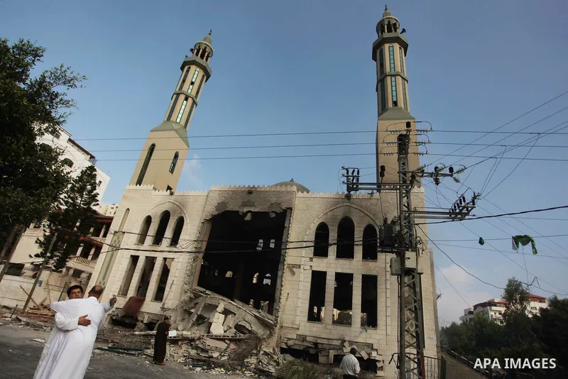 Palestinians react in front of a destroyed mosque after it was hit by an Israeli air strike, on July 29, 2014, in Gaza City. Bloodshed in and around Gaza surged with strikes killing at least 13 Palestinians, a day after...