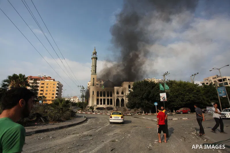 Palestinians react in front of a destroyed mosque after it was hit by an Israeli air strike, on July 29, 2014, in Gaza City. Bloodshed in and around Gaza surged with strikes killing at least 13 Palestinians, a day after...