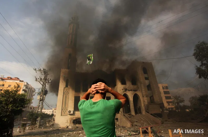 A Palestinian man reacts in front of a destroyed mosque after it was hit by an Israeli air strike, on July 29, 2014, in Gaza City. Bloodshed in and around Gaza surged with strikes killing at least 13 Palestinians, a day...