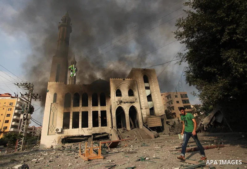 Palestinians react in front of a destroyed mosque after it was hit by an Israeli air strike, on July 29, 2014, in Gaza City. Bloodshed in and around Gaza surged with strikes killing at least 13 Palestinians, a day after...