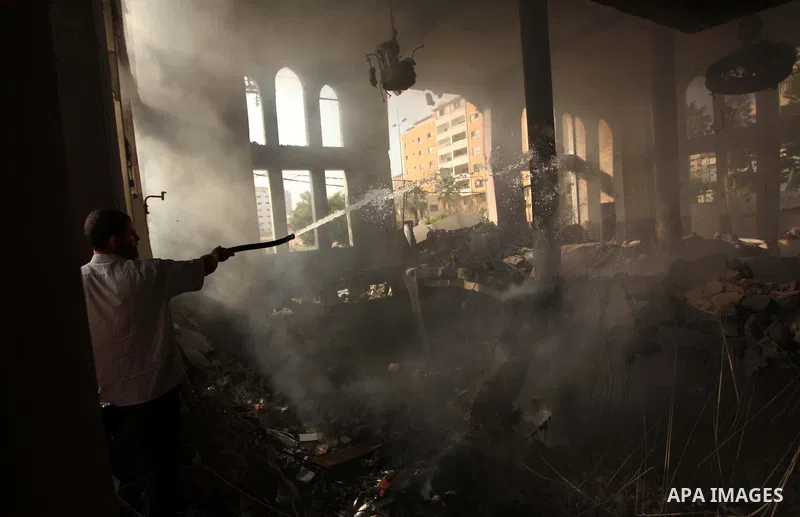 Palestinian firefighters extinguish fire at a mosque after it was hit by an Israeli air strike, on July 29, 2014, in Gaza City. Bloodshed in and around Gaza surged with strikes killing at least 13 Palestinians, a day aft...