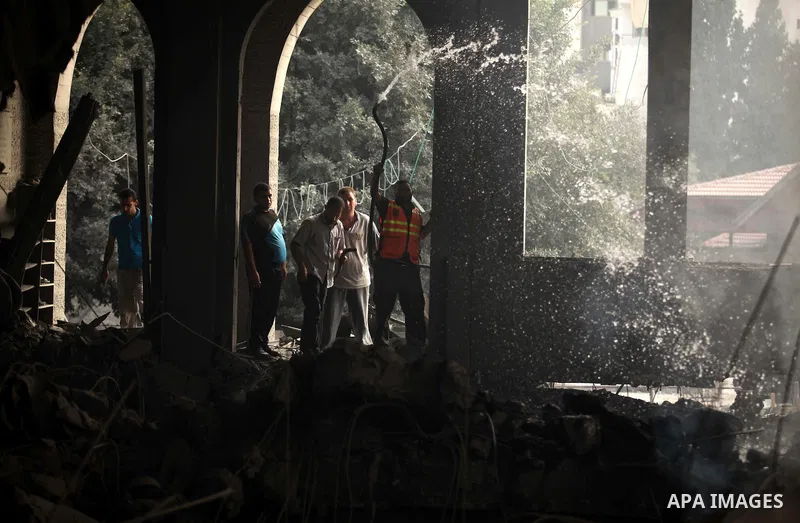 Palestinian firefighters extinguish fire at a mosque after it was hit by an Israeli air strike, on July 29, 2014, in Gaza City. Bloodshed in and around Gaza surged with strikes killing at least 13 Palestinians, a day aft...