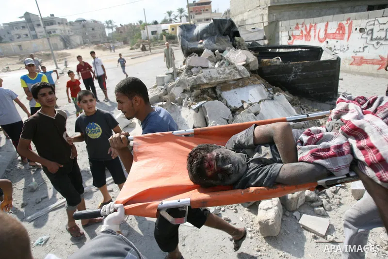 Palestinian man carries the body of Palestinian boy, whom medics said was killed in an Israeli air strike that destroyed her family's house, in Khan Younis in the southern Gaza Strip July 29, 2014. Israel's military poun...