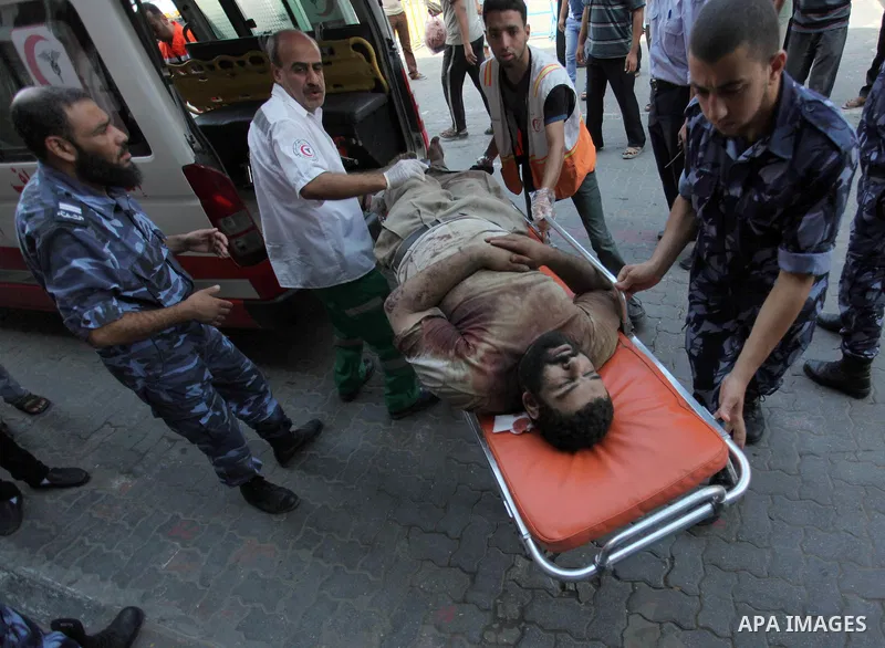 Palestinian medics treat a man, who was wounded in an Israeli air strike, at Nasser hospital in Khan Younis in the southern Gaza Strip, July 29, 2014 Israel knocked out Gaza's only power plant, flattened the home of its...