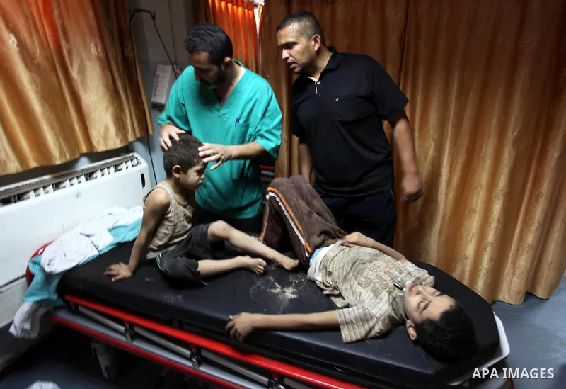 Palestinian medics treat children, who was wounded in an Israeli air strike, at Nasser hospital in Khan Younis in the southern Gaza Strip, July 29, 2014 Israel knocked out Gaza's only power plant, flattened the home of i...