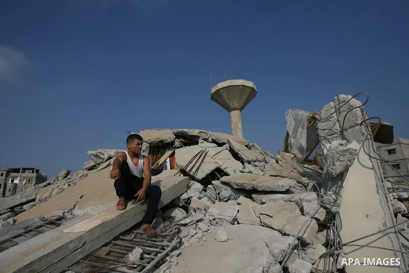 Palestinians search for victims as people gather atop the remains of a house, which witnesses said was destroyed in an Israeli air strike, in Rafah in the southern Gaza Strip July 29, 2014. Israel's military pounded targ...