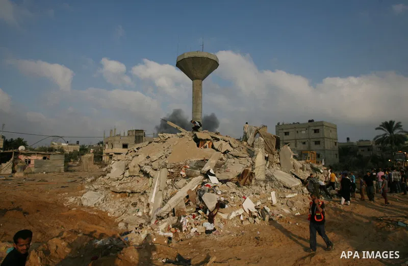Palestinians search for victims as people gather atop the remains of a house, which witnesses said was destroyed in an Israeli air strike, in Rafah in the southern Gaza Strip July 29, 2014. Israel's military pounded targ...