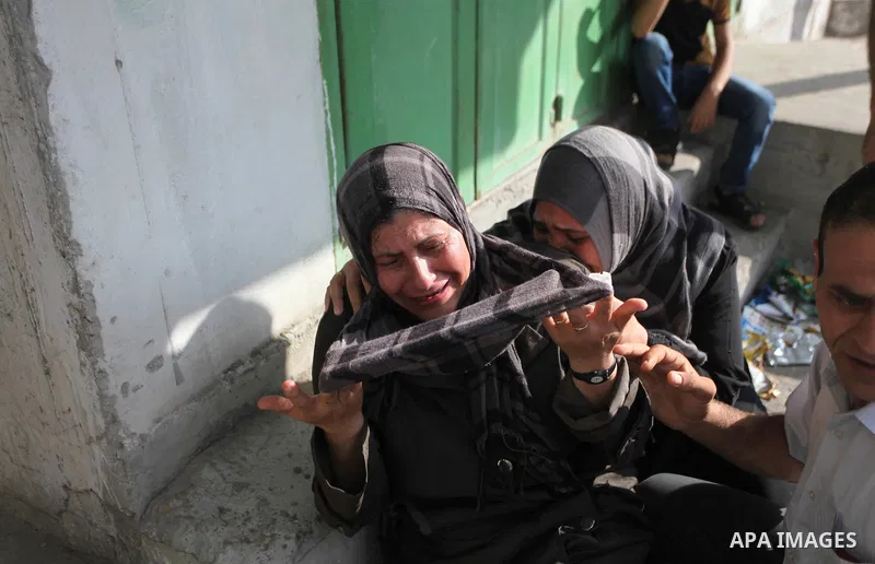 Palestinians who lost relatives in an Israeli strike on a compound housing a UN school in Jabalia refugee camp in the northern Gaza Strip, mourn outside the Kamal Edwin hospital in Beit Lahia where victims from the attac...