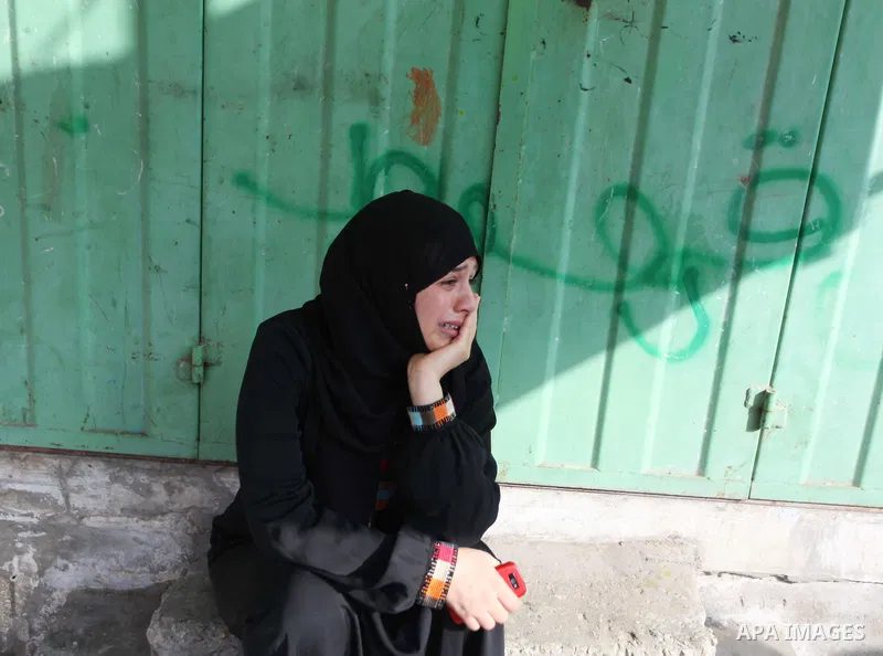 Palestinians who lost relatives in an Israeli strike on a compound housing a UN school in Jabalia refugee camp in the northern Gaza Strip, mourn outside the Kamal Edwin hospital in Beit Lahia where victims from the attac...