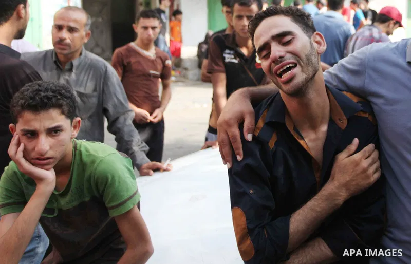 Palestinians who lost relatives in an Israeli strike on a compound housing a UN school in Jabalia refugee camp in the northern Gaza Strip, mourn outside the Kamal Edwin hospital in Beit Lahia where victims from the attac...