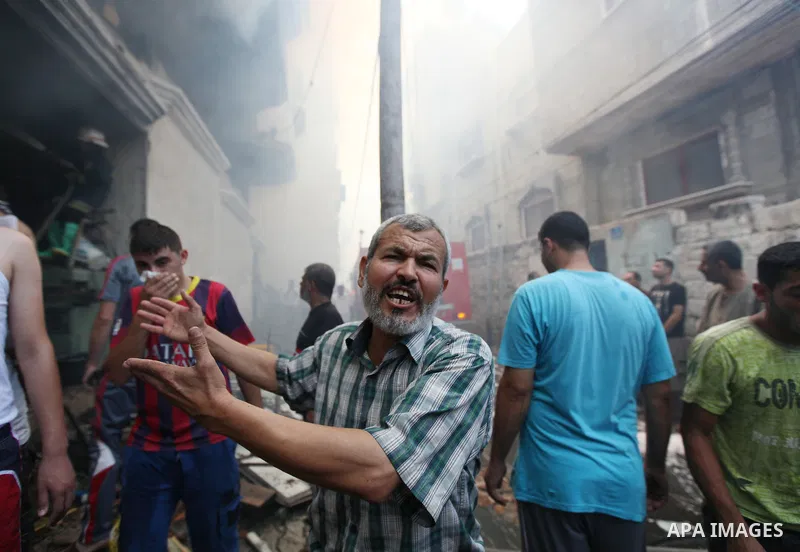 Palestinians try to put out a building on fire following several Israeli strikes on Gaza City on July 30, 2014. So far, according to Palestinian medics, 1,283 people have been killed and more than 7,170 wounded since the...