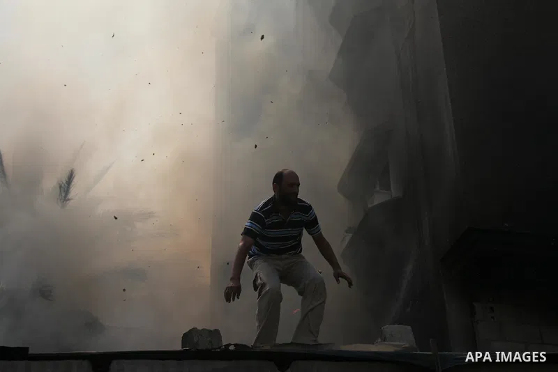 Palestinians try to put out a building on fire following several Israeli strikes on Gaza City on July 30, 2014. So far, according to Palestinian medics, 1,283 people have been killed and more than 7,170 wounded since the...