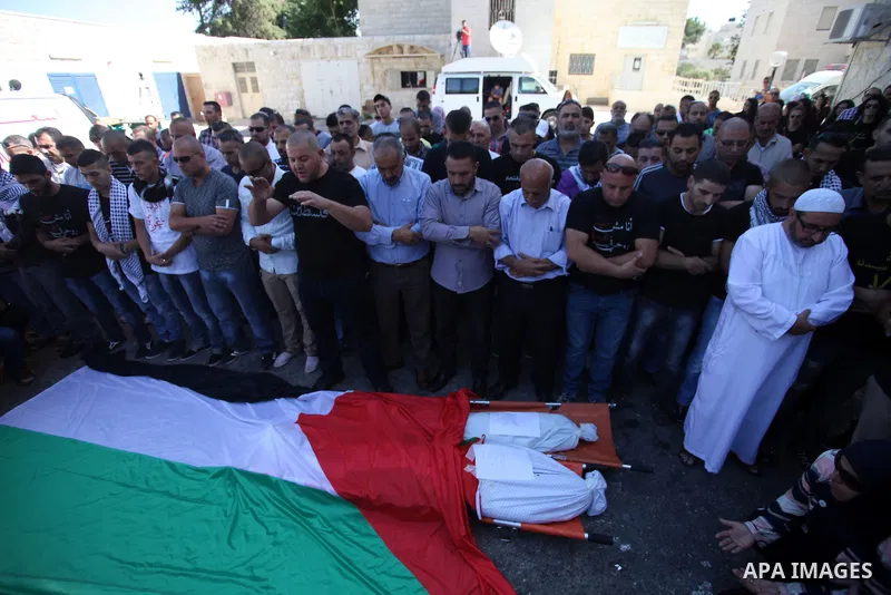 Palestinians mourns two body of Zehir Al-Najar 7, and Ahmed Abu Baler 19, from the Gaza Strip, during thier funeral in East Jerusalem, on July 30, 2014 after they died from injuries sustained following an Israeli militar...