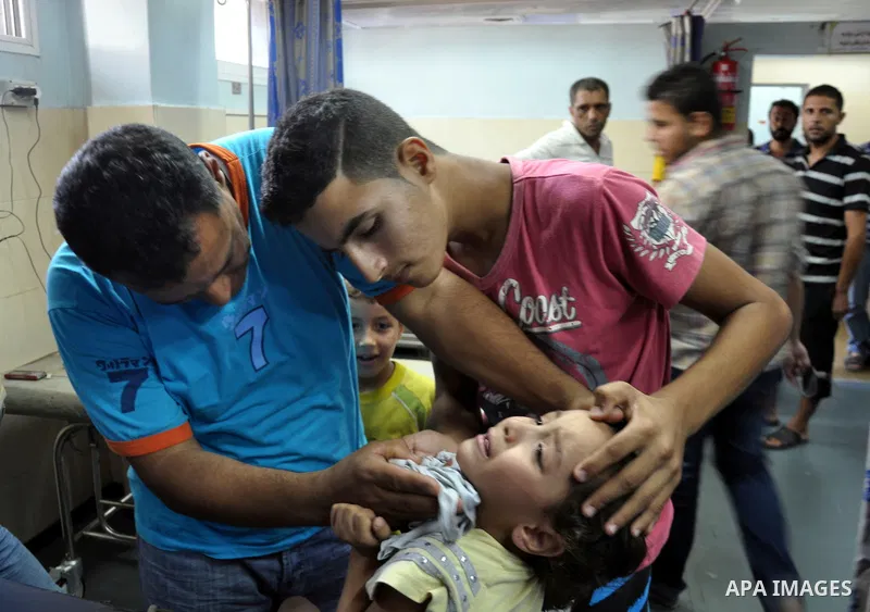 Palestinian medics treat children for their injuries caused by an Israeli strike at a house, at the El-Shifa hospital in Gaza City, Wednesday, July 30, 2014. Several Israeli tank shells slammed into the crowded U.N. scho...