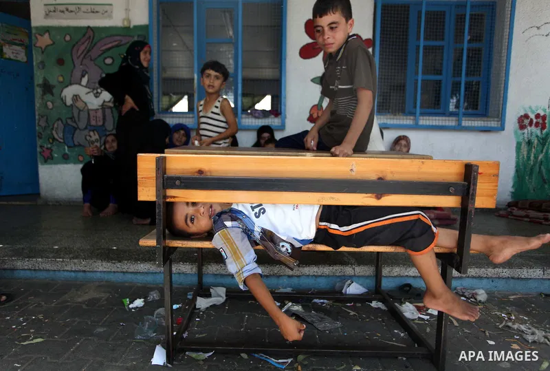 Displaced Palestinian children take shelter at the Abu Hussien UN school in the Jabalia refugee camp in the northern Gaza Strip after the area was hit earlier in the morning by Israeli shelling on July 30, 2014. Israeli...