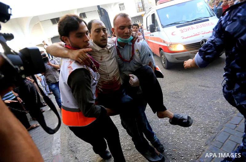 Palestinian medics wheel a wounded man, following an Israeli Strike in Shijaiyah neighborhood, to the emergency room of the Shifa Hospital, in Gaza City, Wednesday, July 30, 2014. Photo by Mohammed Asad