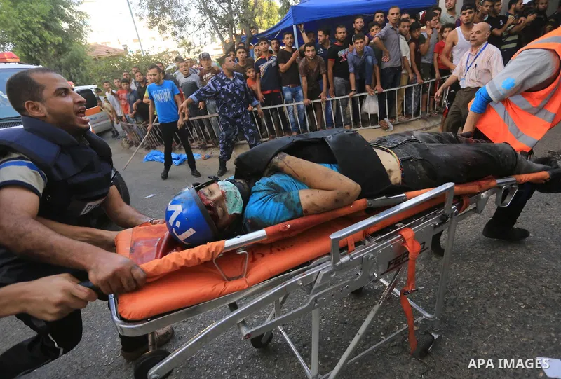 Palestinian medics wheel a wounded Journalist, following an Israeli Strike in Shijaiyah neighborhood, to the emergency room of the Shifa Hospital, in Gaza City, Wednesday, July 30, 2014. Photo by Mohammed Asad