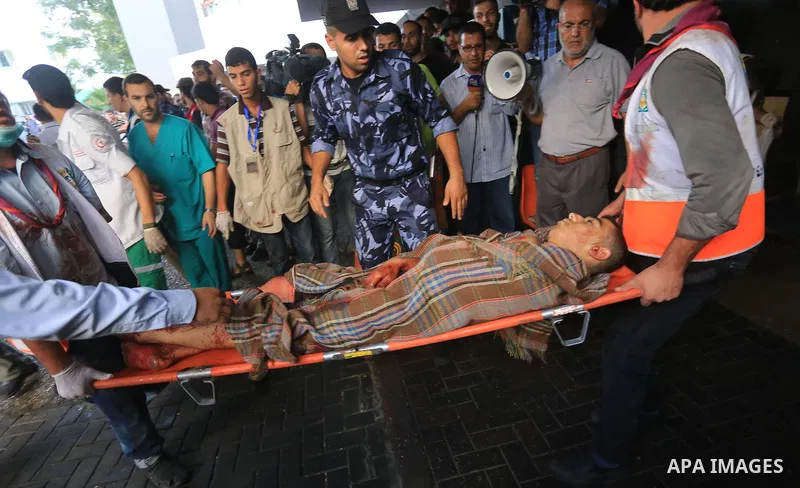 Palestinian medics wheel a wounded man, following an Israeli Strike in Shijaiyah neighborhood, to the emergency room of the Shifa Hospital, in Gaza City, Wednesday, July 30, 2014. Photo by Mohammed Asad