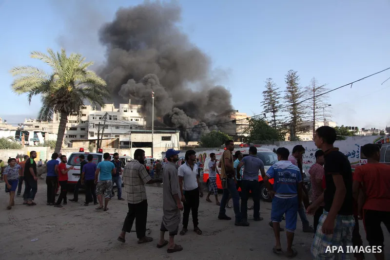 Palestinians help an injured man to an ambulance following an Israeli Strike in Shijaiyah neighborhood, eastern Gaza City, Wednesday, July 30, 2014. At least 15 people were killed and 200 people wounded in an Israeli air...