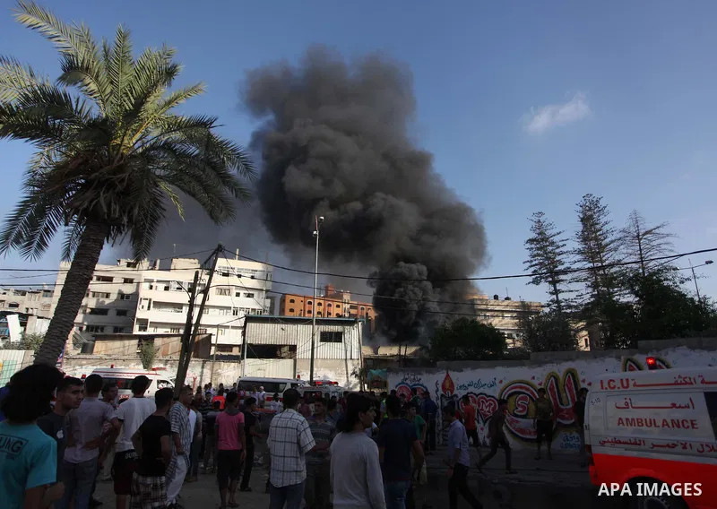 Palestinians help an injured man to an ambulance following an Israeli Strike in Shijaiyah neighborhood, eastern Gaza City, Wednesday, July 30, 2014. At least 15 people were killed and 200 people wounded in an Israeli air...