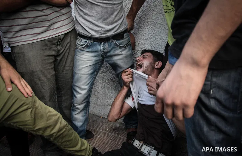 Palestinians cry after identifying their loved one, killed on an Israeli strike in Shijaiyah neighbourhood, at the morgue of Gaza City's Shifa hospital, Wednesday July 30, 2014. Israeli strikes hit the crowded shopping a...
