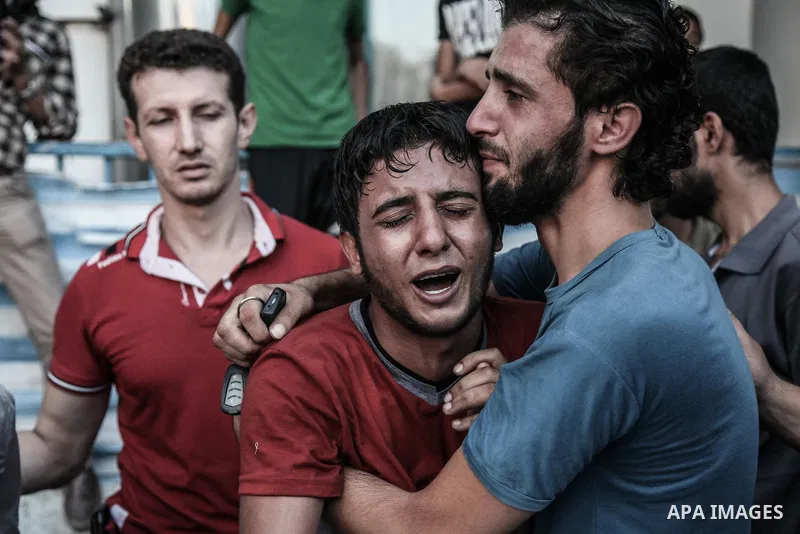 Palestinians cry after identifying their loved one, killed on an Israeli strike in Shijaiyah neighbourhood, at the morgue of Gaza City's Shifa hospital, Wednesday July 30, 2014. Israeli strikes hit the crowded shopping a...