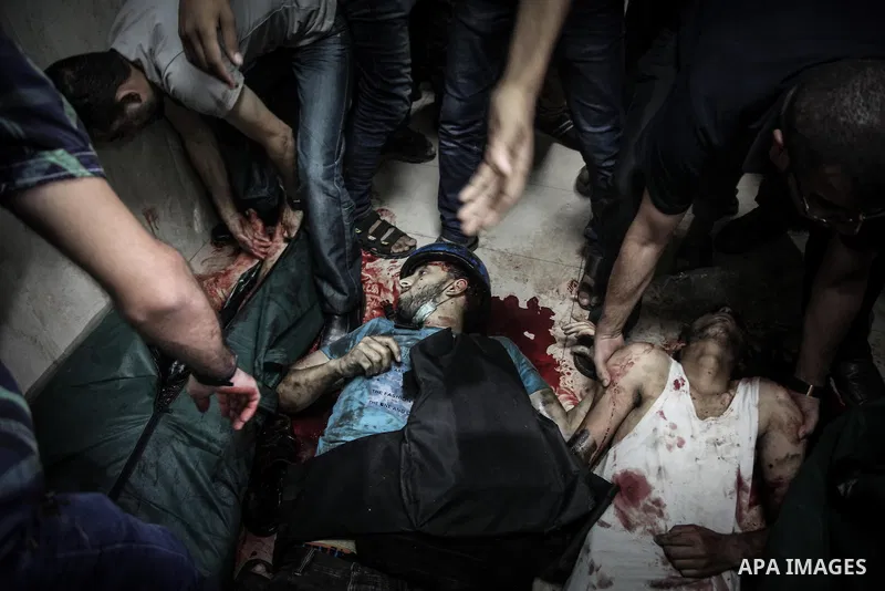 Palestinians wheel the lifeless body of video journalist, Rami Rayan, following an Israeli Strike in Shijaiyah neighborhood, to the emergency room of the Shifa Hospital, in Gaza City, Wednesday, July 30, 2014.Photo by Ez...