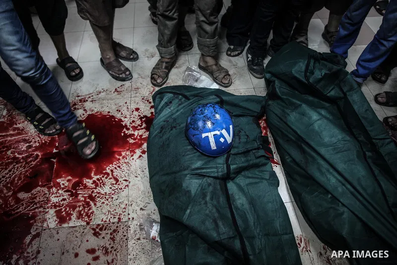 Palestinians wheel the lifeless body of video journalist, Rami Rayan, following an Israeli Strike in Shijaiyah neighborhood, to the emergency room of the Shifa Hospital, in Gaza City, Wednesday, July 30, 2014.Photo by Ez...