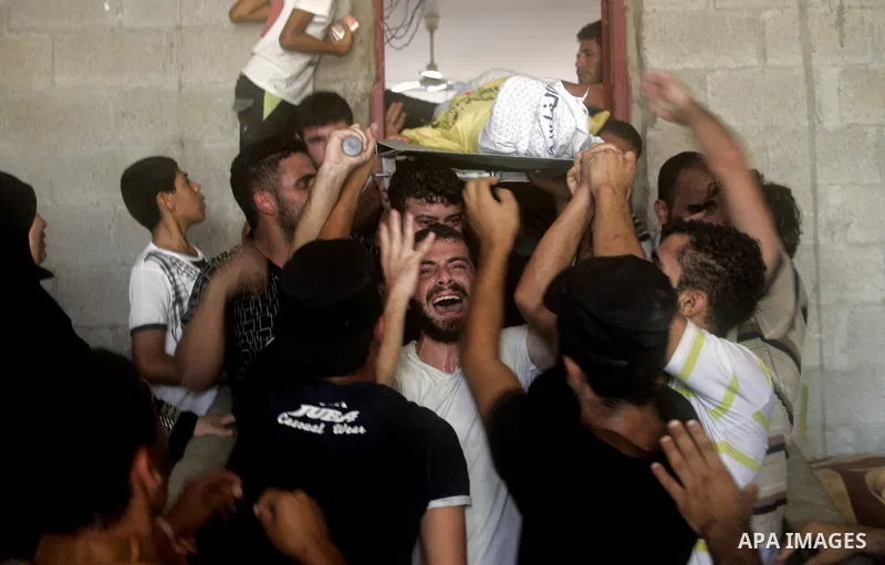 Palestinians carry the bodies Palestinian killed in Israeli strike, during their funeral in Gaza city, July 30, 2014. Israeli bombardments early on July 30 killed "dozens" of Palestinians in Gaza, including at least 16 a...