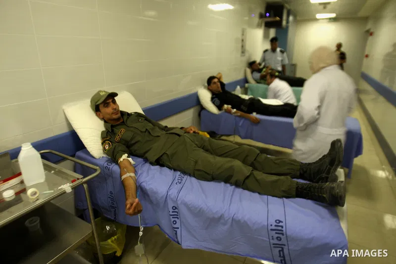 Palestinian policemen donate blood during a campaign of blood donation for Gaza strip, at hospital in the West Bank city of Nablus, on July 31, 2014. At least 10 people were killed in fresh Israeli strikes in central and...