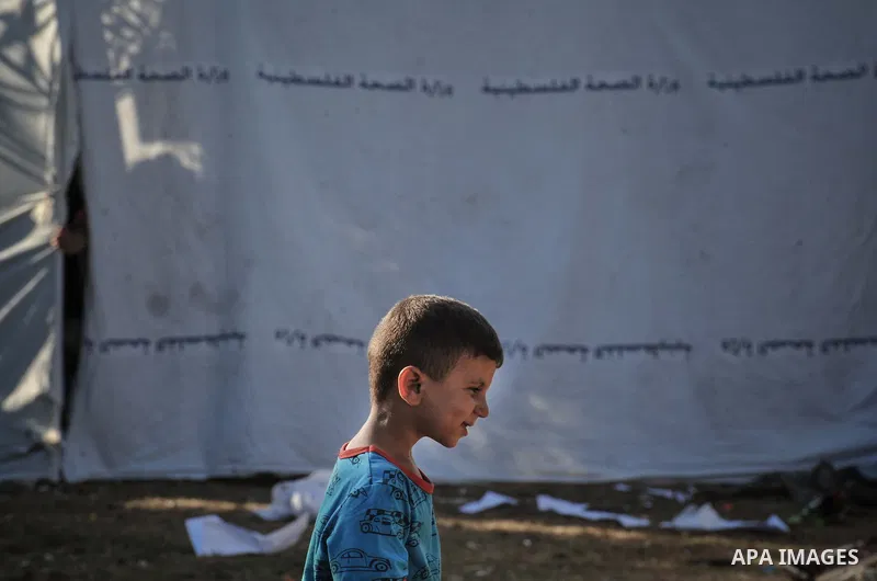 A displaced Palestinian boy plays at the al-Shifa hospital in Gaza City where many Palestinians have have taken refuge after fleeing attacks in the Shejaiya neighbourhood of the city, on July 31, 2014. With more than 220...