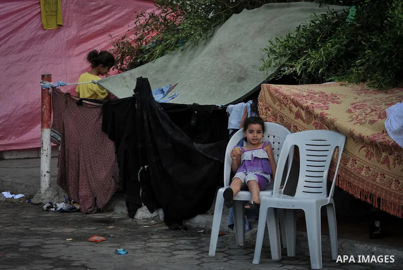 Displaced Palestinians gather at the al-Shifa hospital in Gaza City where they have taken refuge after fleeing heavy fighting in the Shejaiya neighbourhood of the city, on July 31, 2014. With more than 220,000 Palestinia...