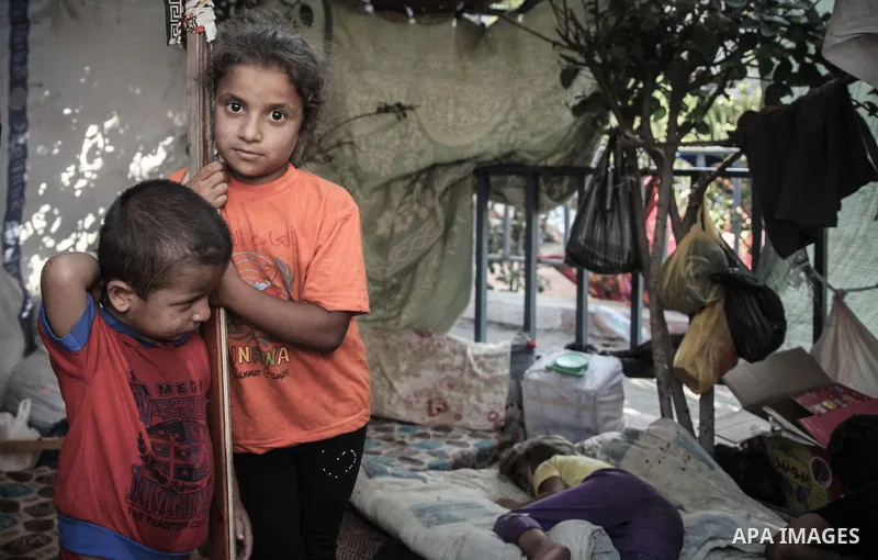 Displaced Palestinians gather at the al-Shifa hospital in Gaza City where they have taken refuge after fleeing heavy fighting in the Shejaiya neighbourhood of the city, on July 31, 2014. With more than 220,000 Palestinia...
