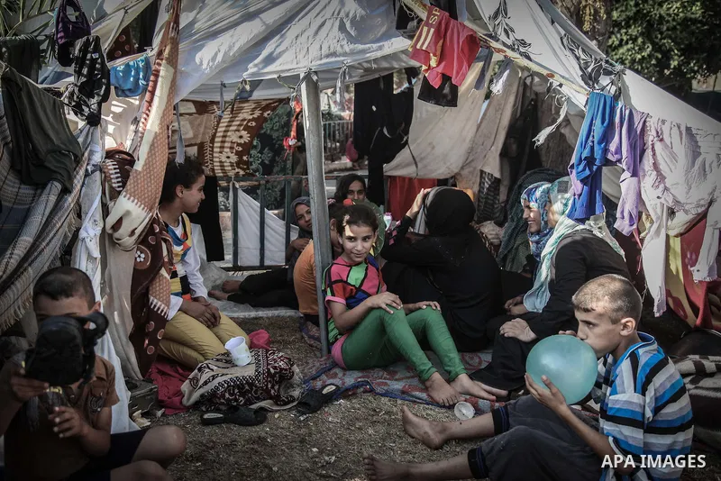 Displaced Palestinians gather at the al-Shifa hospital in Gaza City where they have taken refuge after fleeing heavy fighting in the Shejaiya neighbourhood of the city, on July 31, 2014. With more than 220,000 Palestinia...