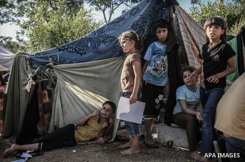 Displaced Palestinians gather at the al-Shifa hospital in Gaza City where they have taken refuge after fleeing heavy fighting in the Shejaiya neighbourhood of the city, on July 31, 2014. With more than 220,000 Palestinia...