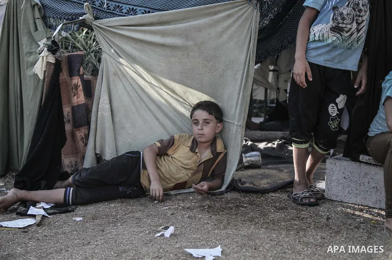 Displaced Palestinians gather at the al-Shifa hospital in Gaza City where they have taken refuge after fleeing heavy fighting in the Shejaiya neighbourhood of the city, on July 31, 2014. With more than 220,000 Palestinia...