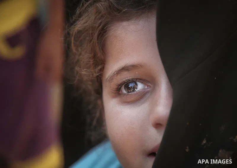 A displaced Palestinian girl stands next to a makeshift tent at the al-Shifa hospital in Gaza City where many Palestinians have have taken refuge after fleeing attacks in the Shejaiya neighbourhood of the city, on July 3...
