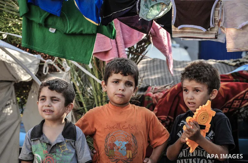 Displaced Palestinian children gather at the al-Shifa hospital in Gaza City where they have taken refuge after fleeing heavy fighting in the Shejaiya neighbourhood of the city, on July 31, 2014. With more than 220,000 Pa...