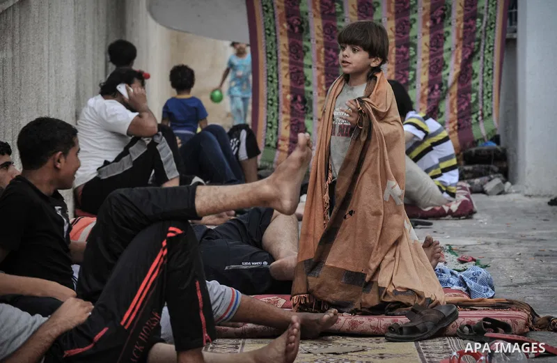 Displaced Palestinians gather at the al-Shifa hospital in Gaza City where they have taken refuge after fleeing heavy fighting in the Shejaiya neighbourhood of the city, on July 31, 2014. With more than 220,000 Palestinia...