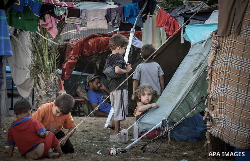 Displaced Palestinians gather at the al-Shifa hospital in Gaza City where they have taken refuge after fleeing heavy fighting in the Shejaiya neighbourhood of the city, on July 31, 2014. With more than 220,000 Palestinia...