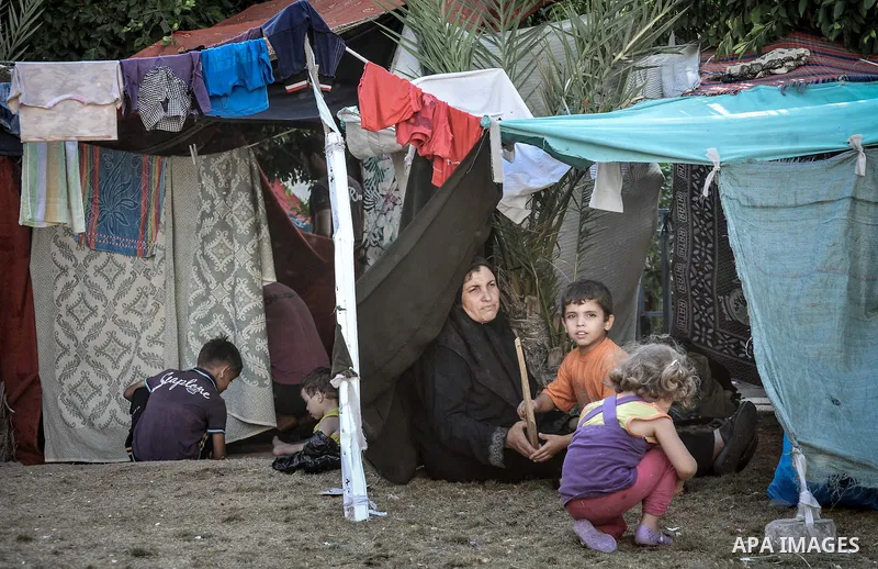 Displaced Palestinians gather at the al-Shifa hospital in Gaza City where they have taken refuge after fleeing heavy fighting in the Shejaiya neighbourhood of the city, on July 31, 2014. With more than 220,000 Palestinia...
