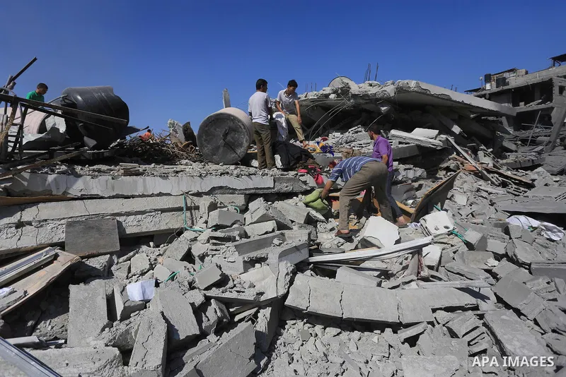 Palestinians walks across the rubble of destroyed buildings and homes in Al-Salam neighbourhood, in Jabalia in the northern Gaza Strip on August 1, 2014. A 72-hour ceasefire took effect today in Gaza but was immediately...