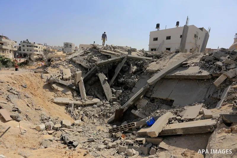 Palestinians walks across the rubble of destroyed buildings and homes in Al-Salam neighbourhood, in Jabalia in the northern Gaza Strip on August 1, 2014. A 72-hour ceasefire took effect today in Gaza but was immediately...