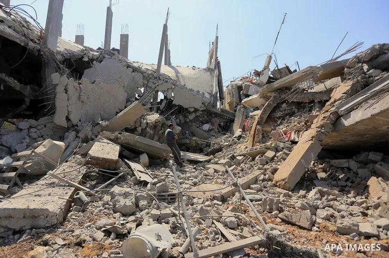 Palestinians walks across the rubble of destroyed buildings and homes in Al-Salam neighbourhood, in Jabalia in the northern Gaza Strip on August 1, 2014. A 72-hour ceasefire took effect today in Gaza but was immediately...