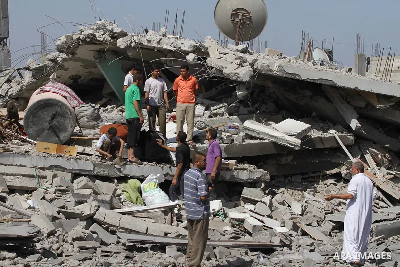 Palestinians walks across the rubble of destroyed buildings and homes in Al-Salam neighbourhood, in Jabalia in the northern Gaza Strip on August 1, 2014. A 72-hour ceasefire took effect today in Gaza but was immediately...